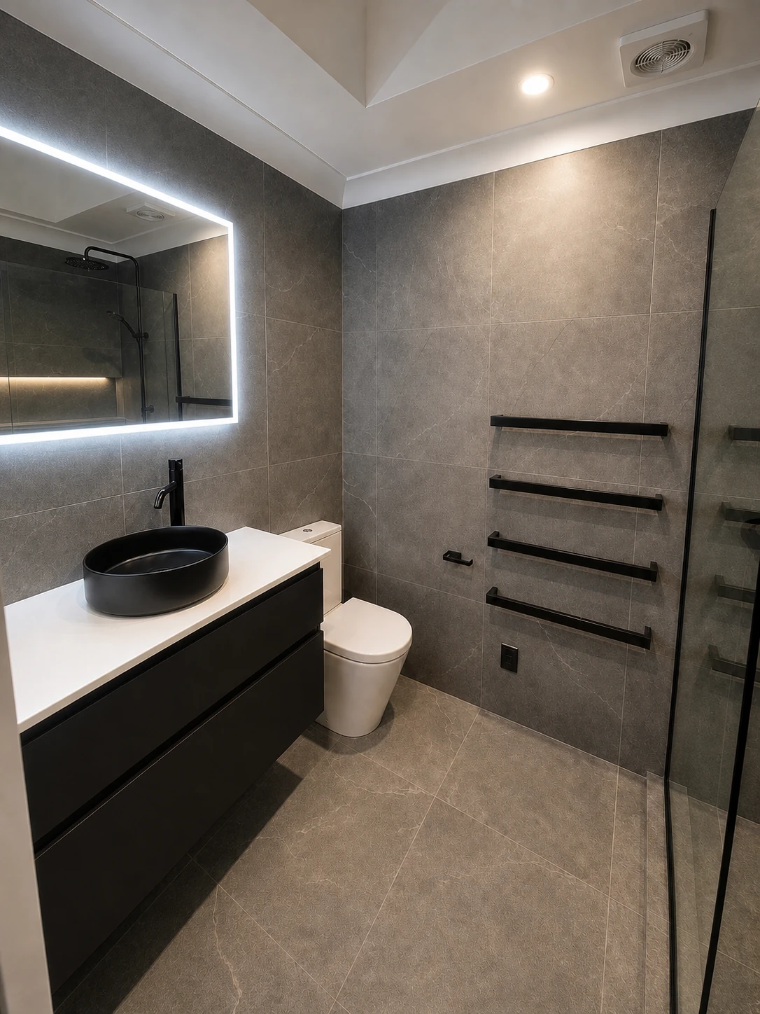 Grey tiled bathroom with walk-in shower and vanity