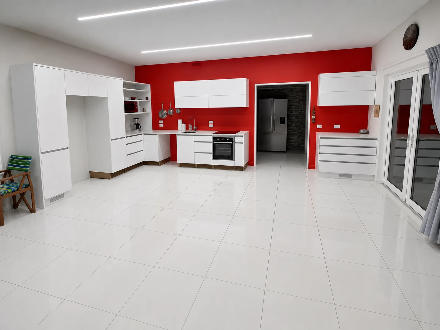 Large white floor tiles in an open kitchen and living area